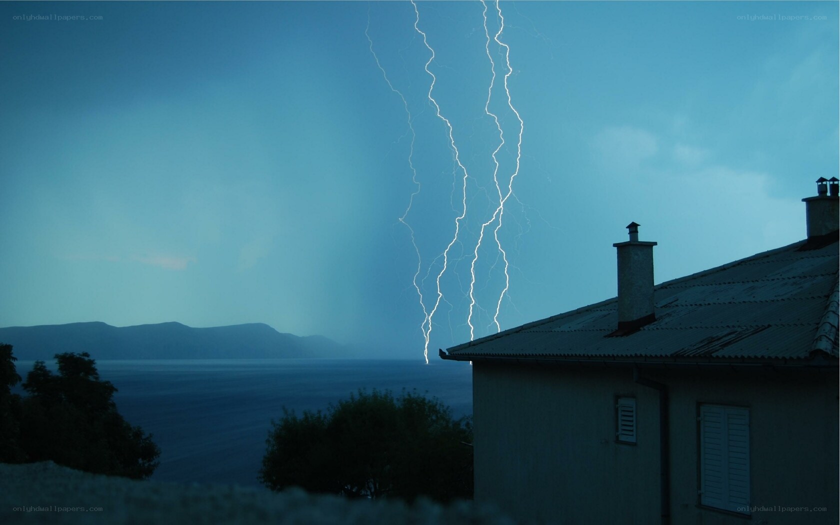 Lightning over coastal house