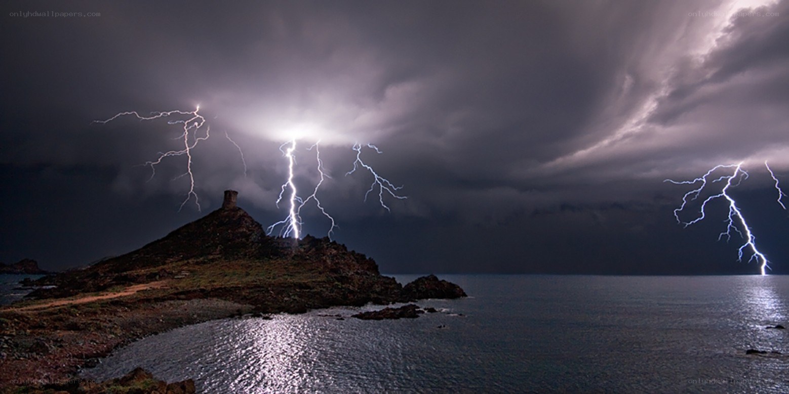 Lightning over coastal rock formation