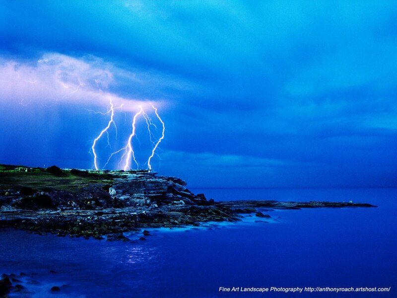 Lightning over coastal rocks