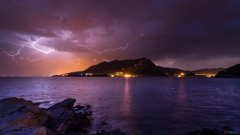 Lightning over Coastal Town — Purple, Dramatic