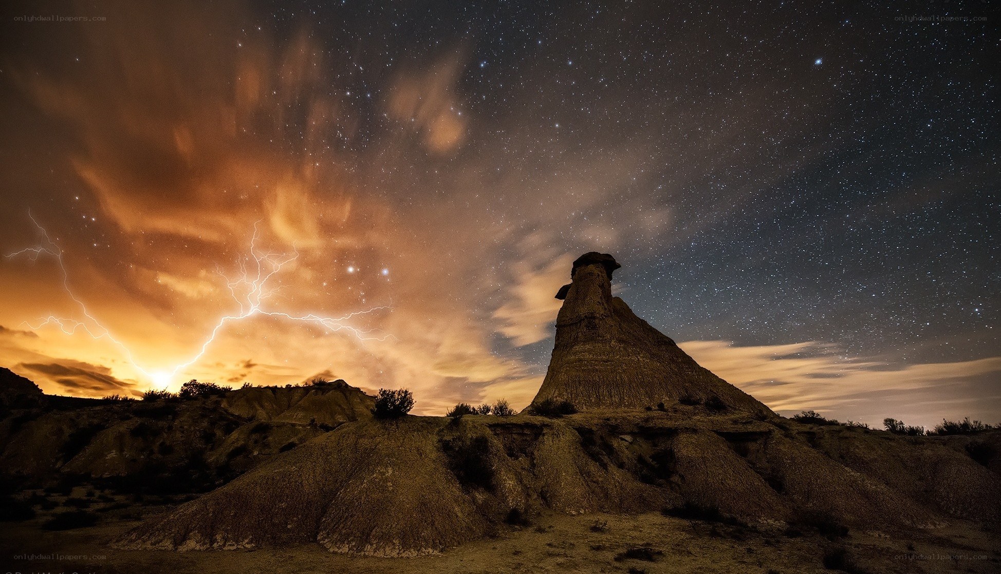 Lightning over desert rock formation