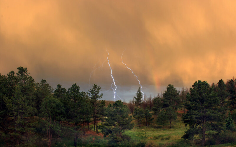 Lightning over Forest — Orange, Dramatic, Sunset, Photograph, Trees, Storm Clouds, Rainbow, Green, Gray