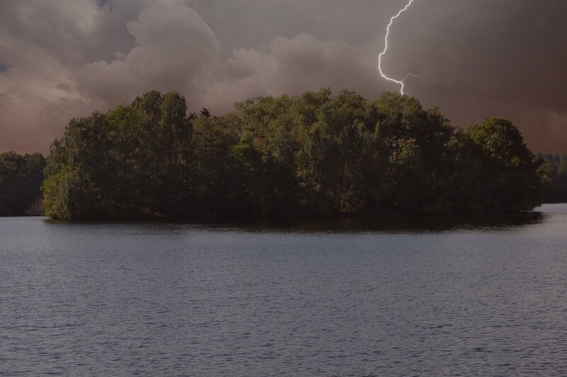 Lightning over forested island