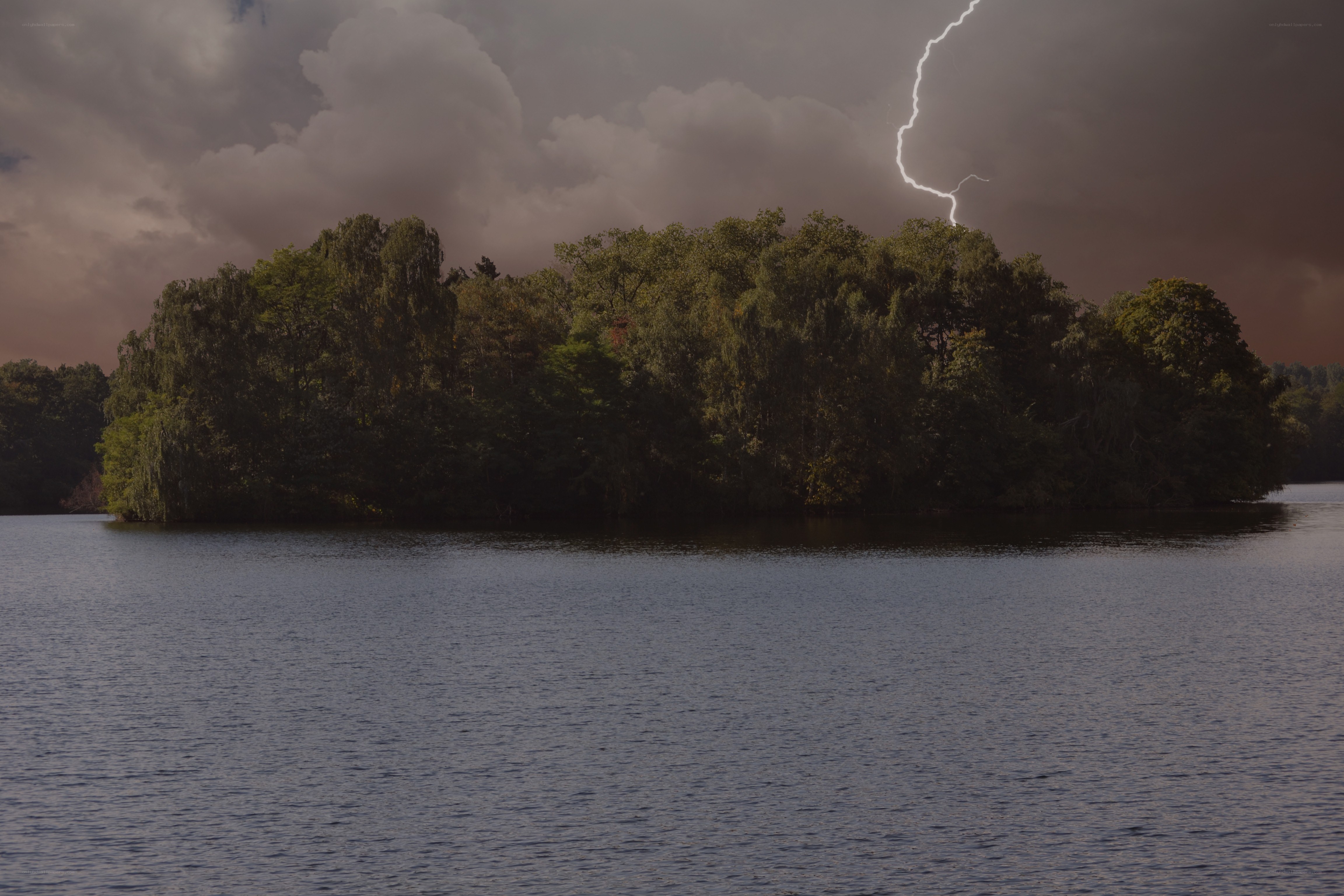 Lightning over forested island