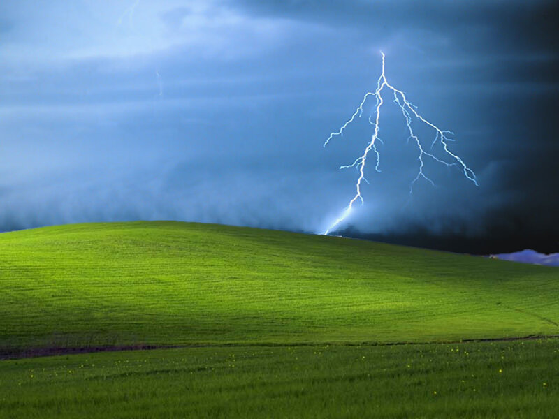 Lightning over green hills