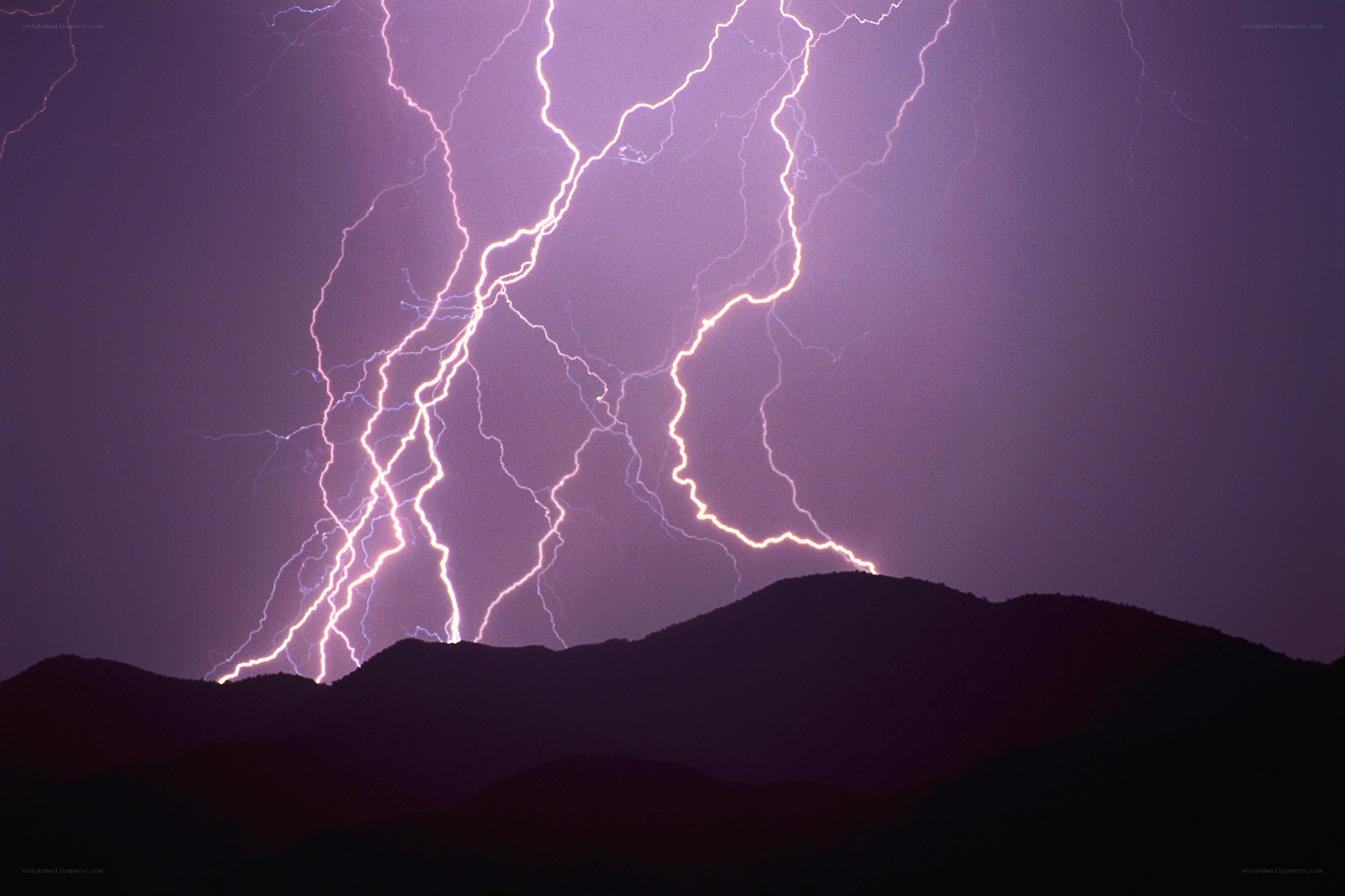 Lightning over mountain silhouette