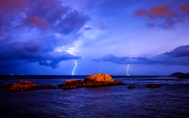 Lightning over Ocean — Blue, Dramatic, Night, Photograph, Clouds, Rocks, Sea