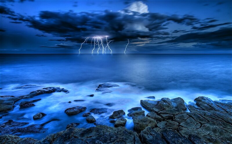 Lightning over Ocean — Blue, Dramatic, Night, Photograph, Clouds, Rocks, Waves