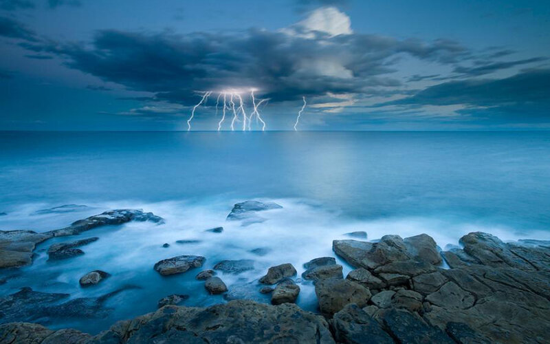 Lightning over Ocean — Blue, Dramatic, Night, Photograph, Clouds, Rocks, Waves, White