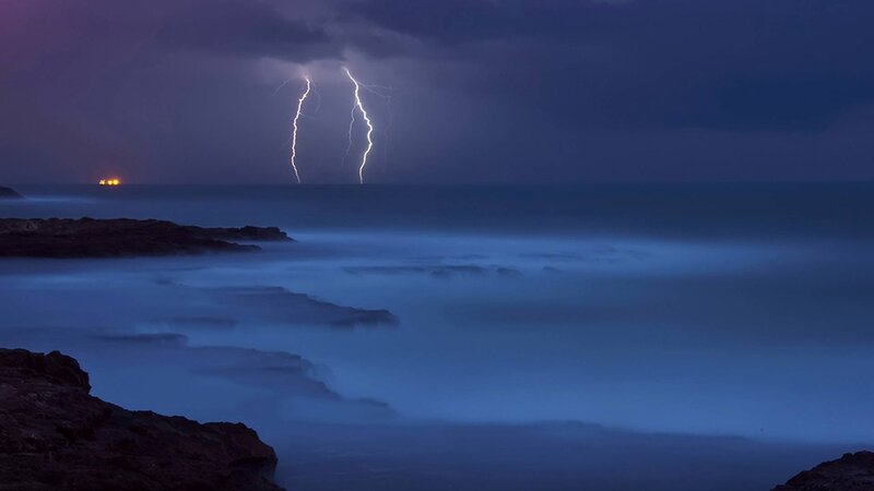 Lightning over Ocean — Blue, Dramatic, Night, Photograph, Storm, Rocks, Ship Lights
