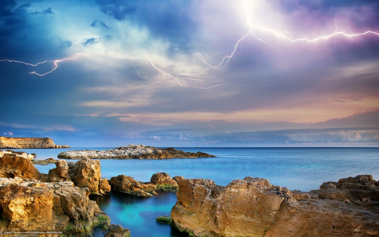 Lightning over rocky coastline