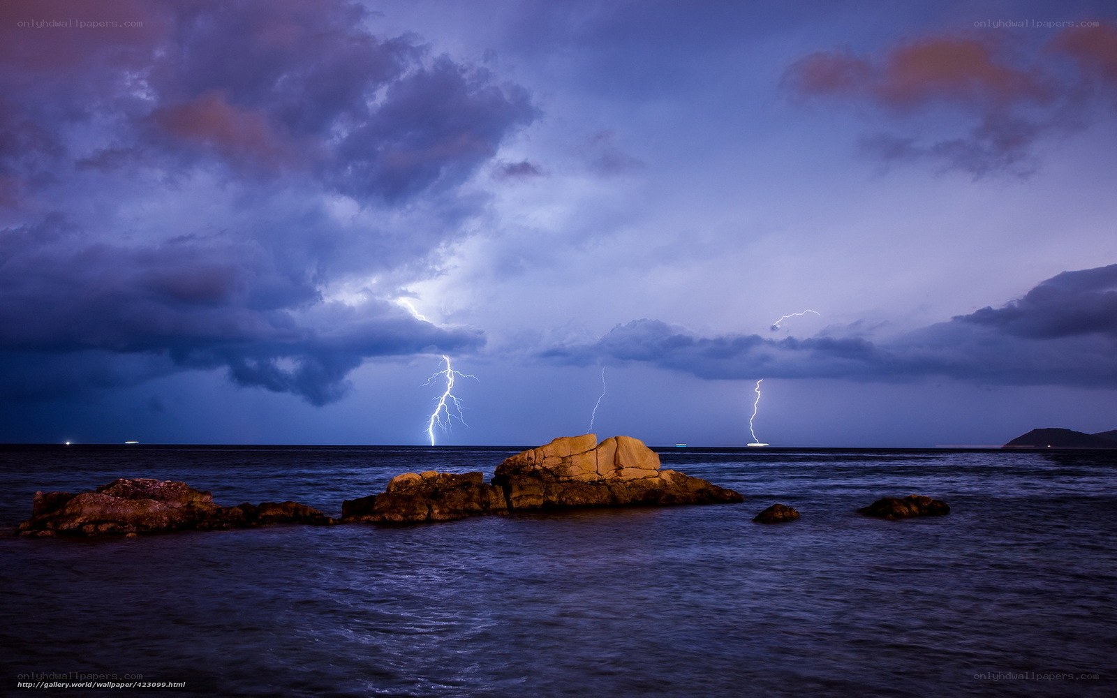 Lightning over rocky coastline