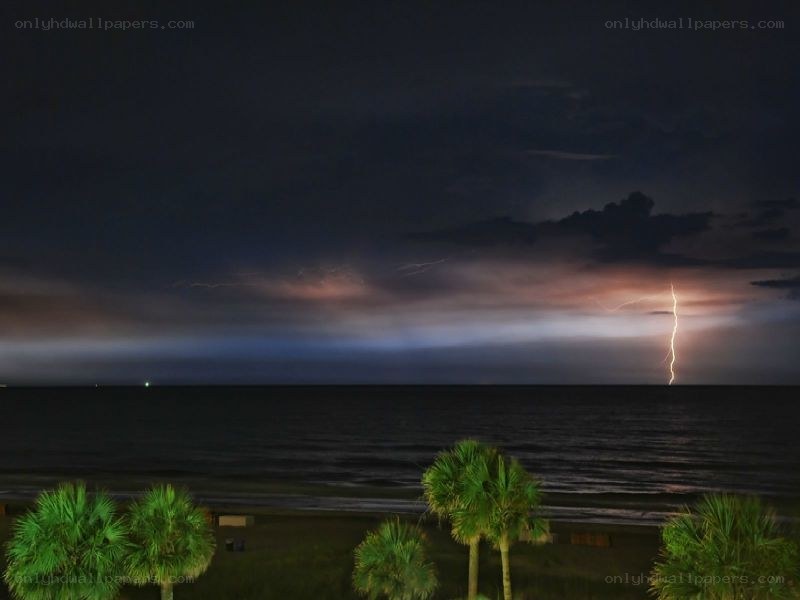 Lightning over the ocean at night