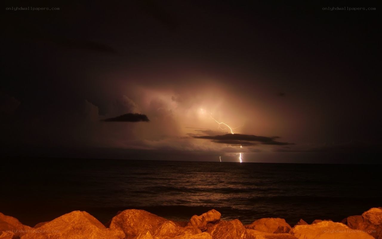 Lightning over the ocean at night