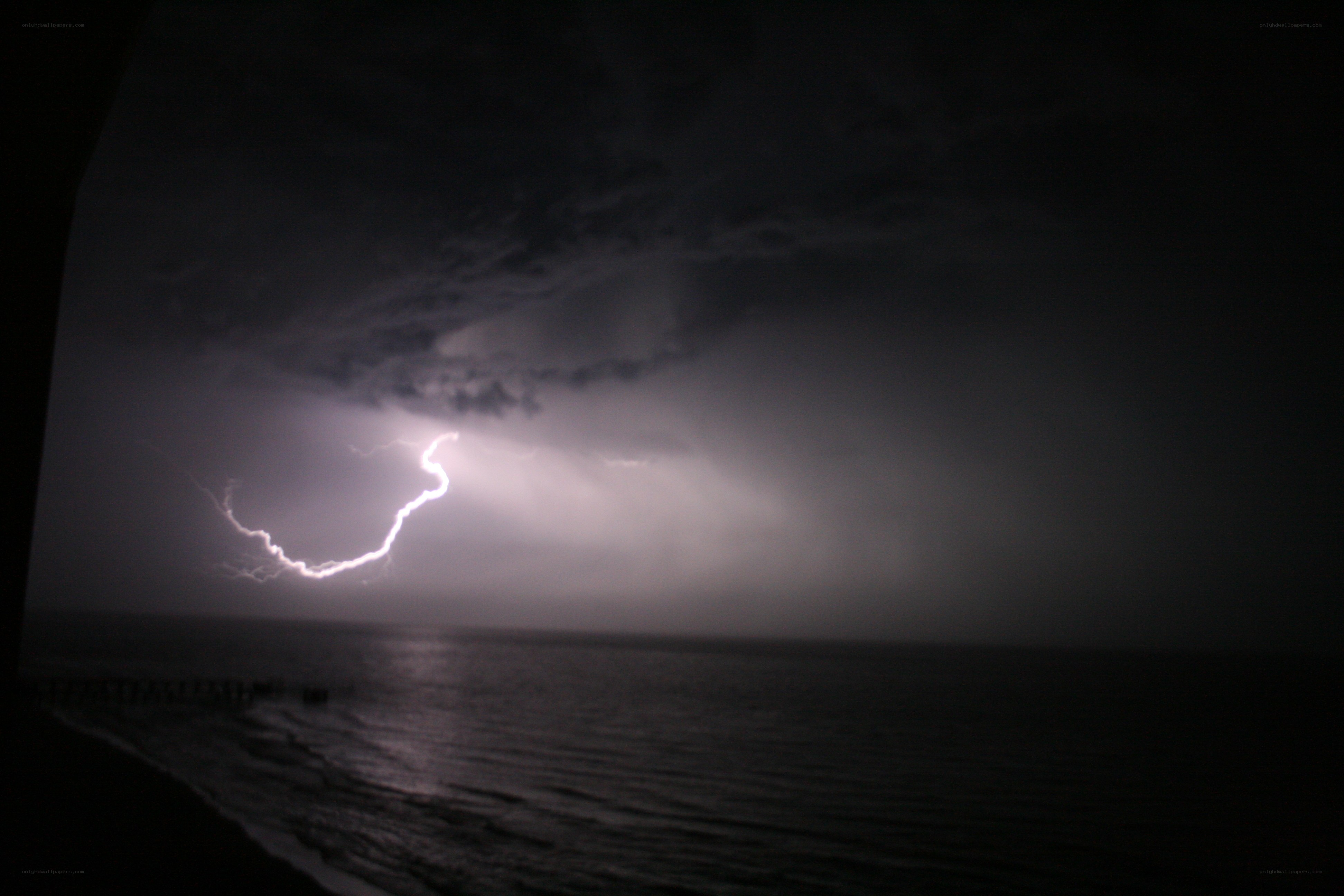 Lightning over the ocean at night