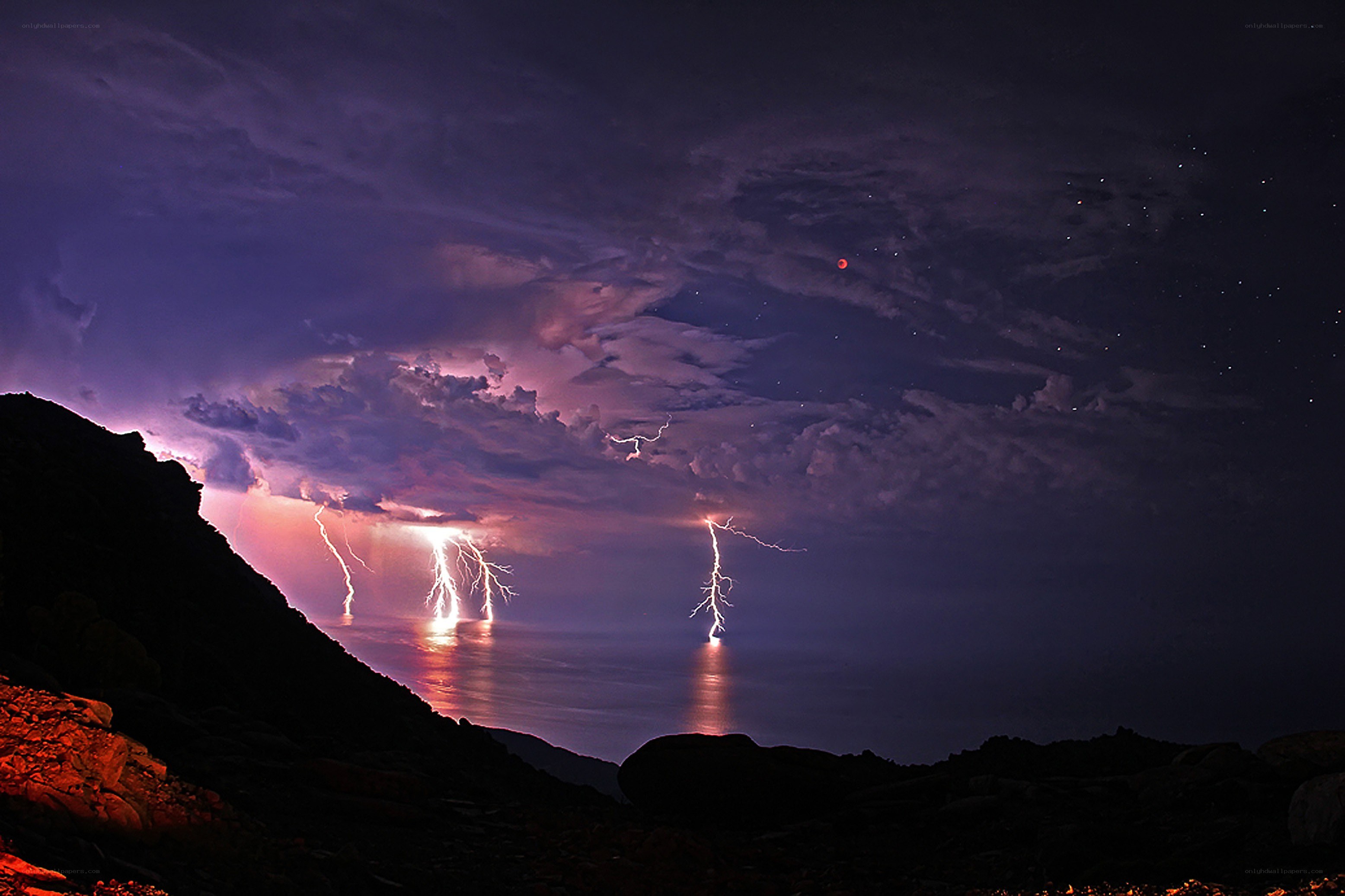 Lightning over the ocean at night