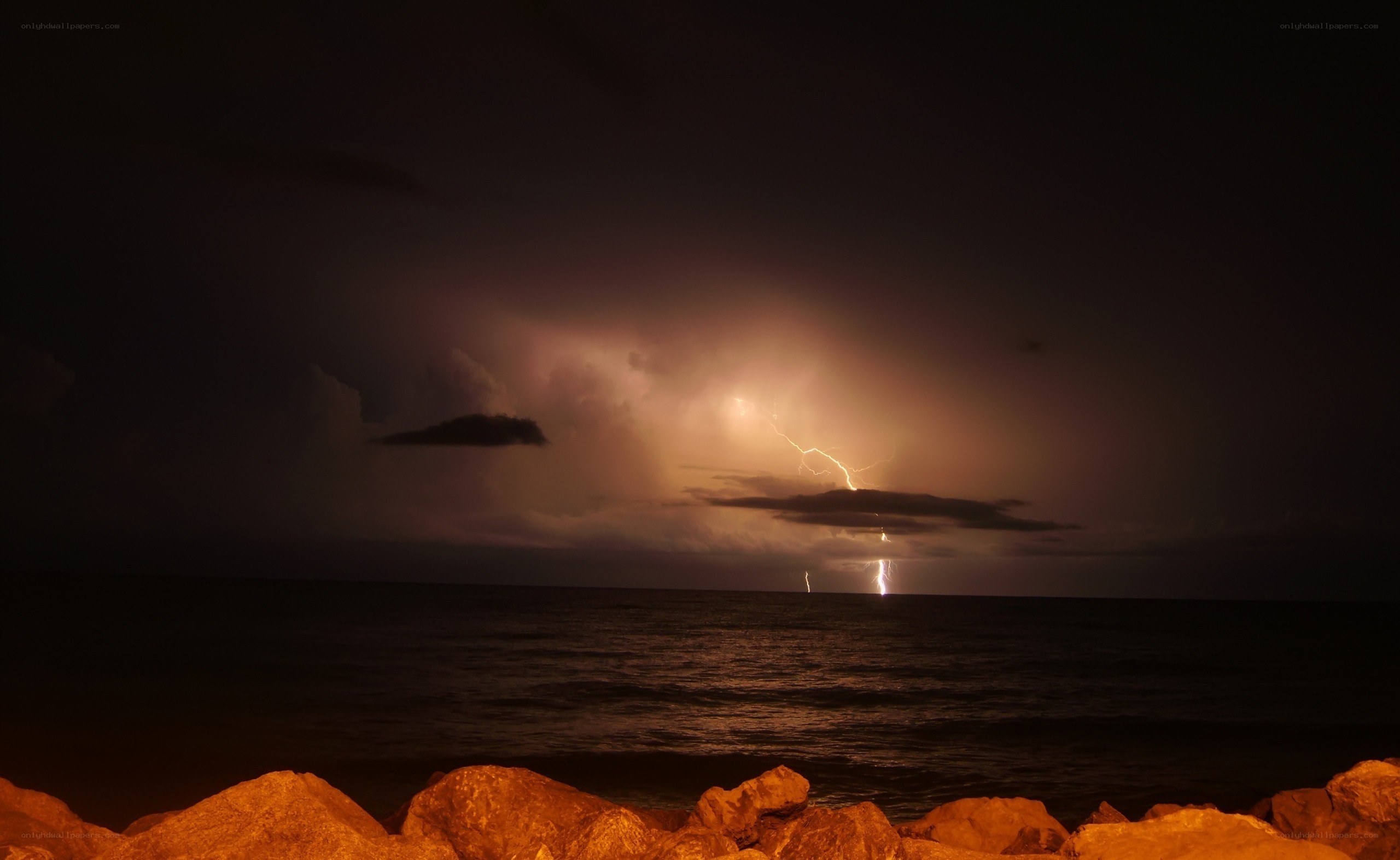 Lightning over the ocean at night