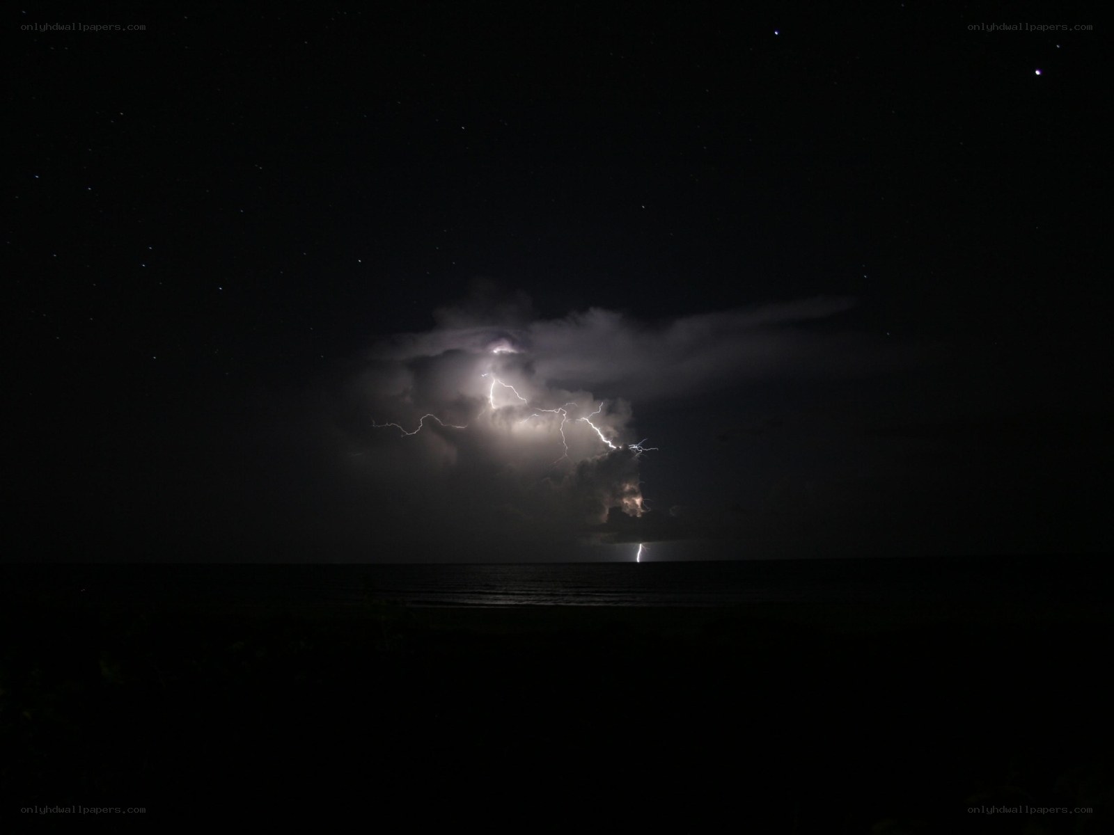 Lightning over the ocean at night