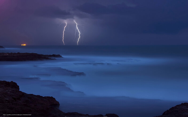 Lightning over the ocean at night