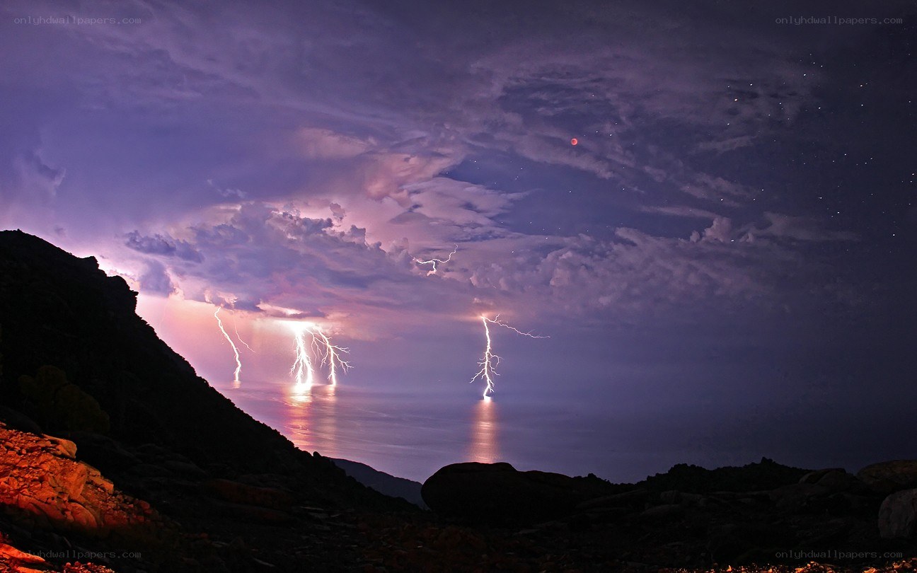 Lightning over the sea at night