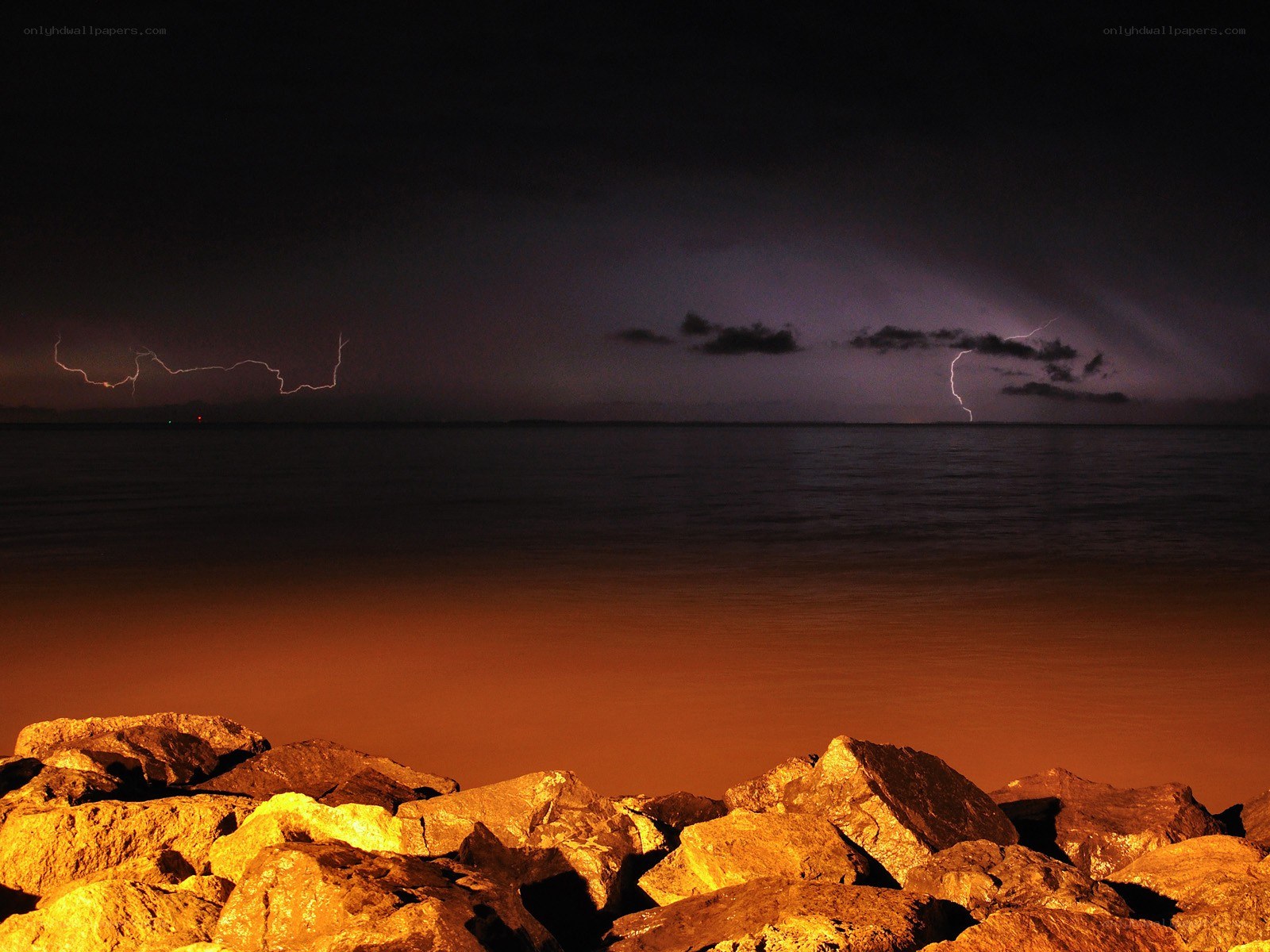 Lightning over the sea at night