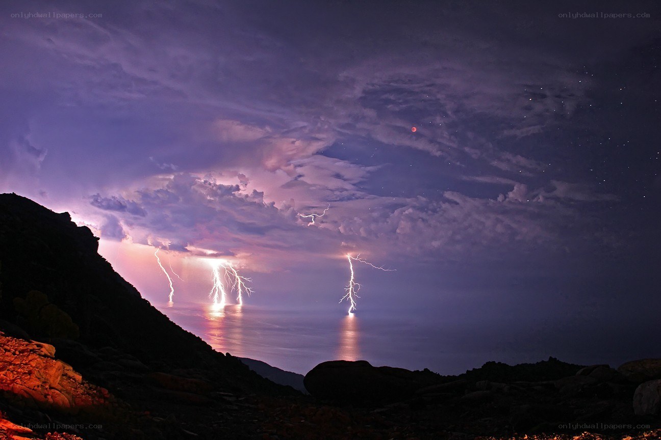 Lightning over the sea at night