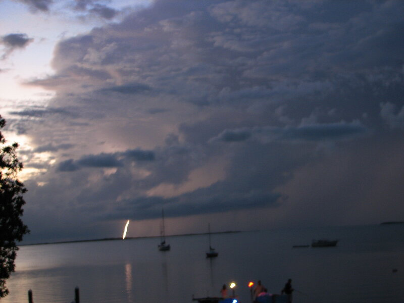 Lightning over the water at dusk