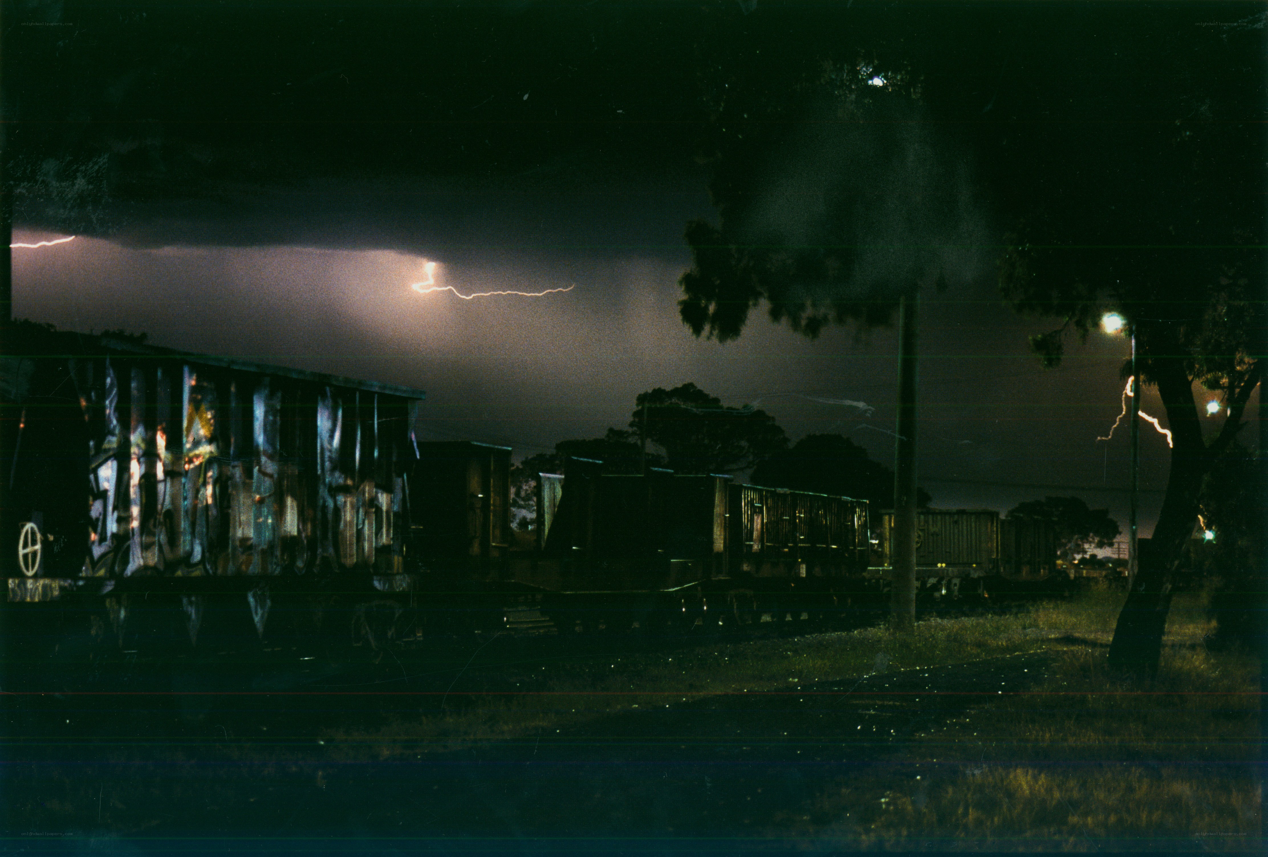 Lightning over train cars at night