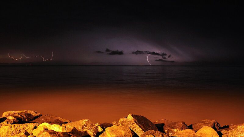 Lightning over Water — Black, Dramatic, Night, Photograph, Rocks, Sea