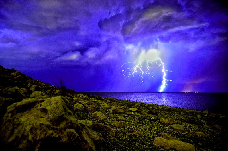 Lightning over Water — Purple, Dramatic, Night, Photograph, Clouds, Rocks