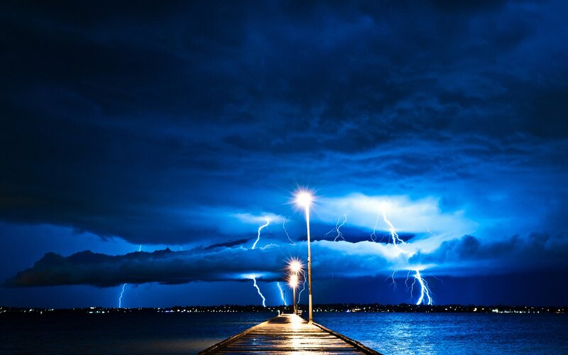 Lightning storm over a pier