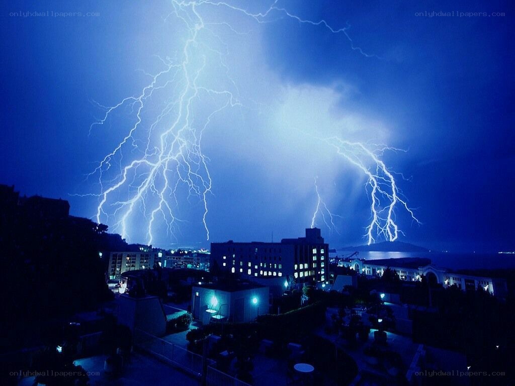 Lightning storm over city at night