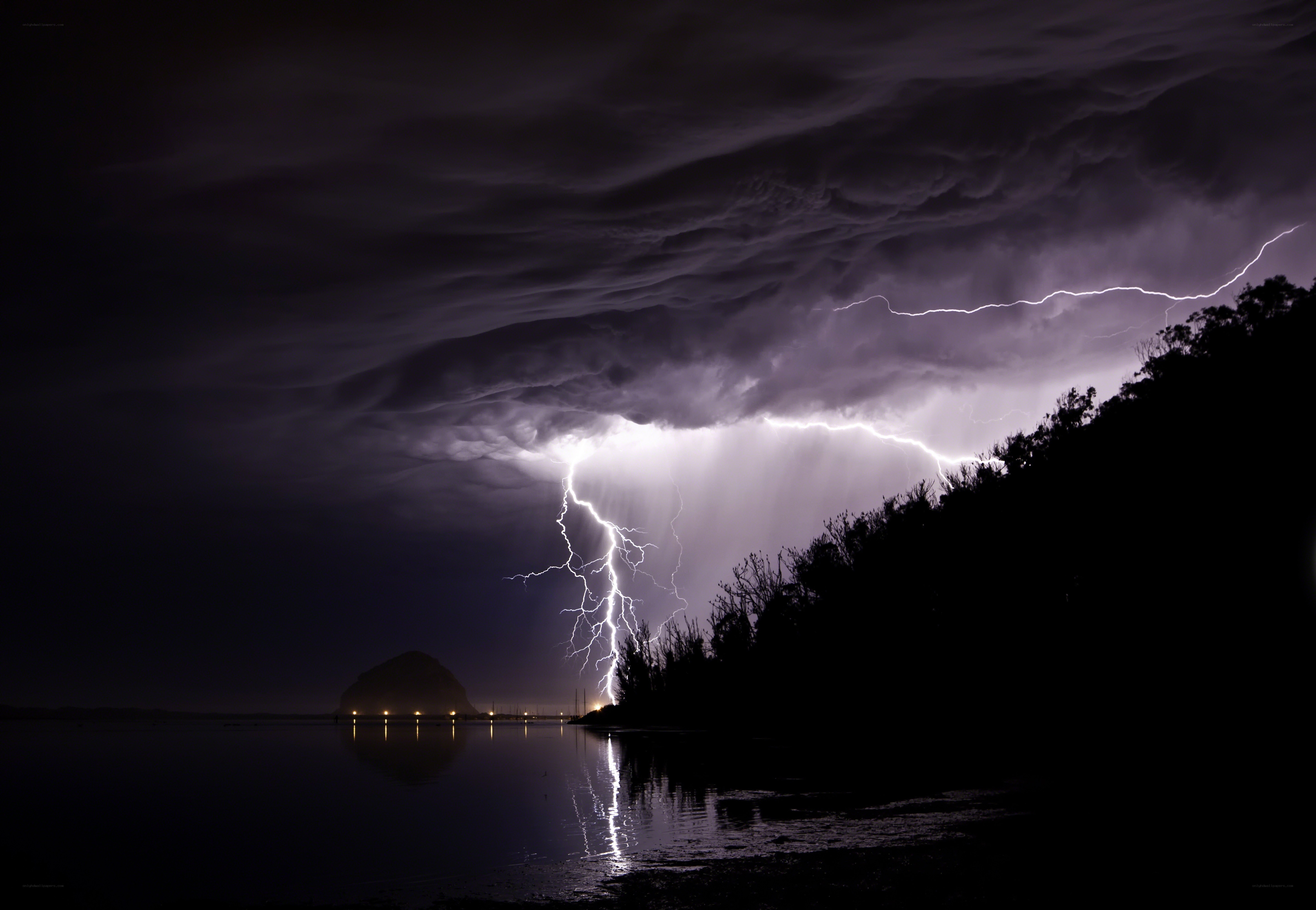 Lightning storm over coastal bay
