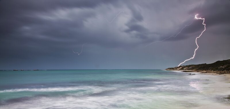 Lightning storm over coastal beach