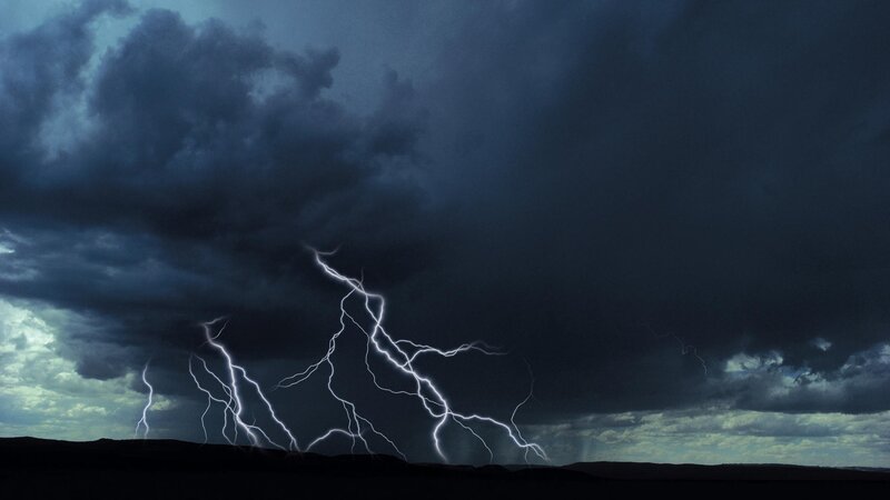 Lightning storm over dark landscape