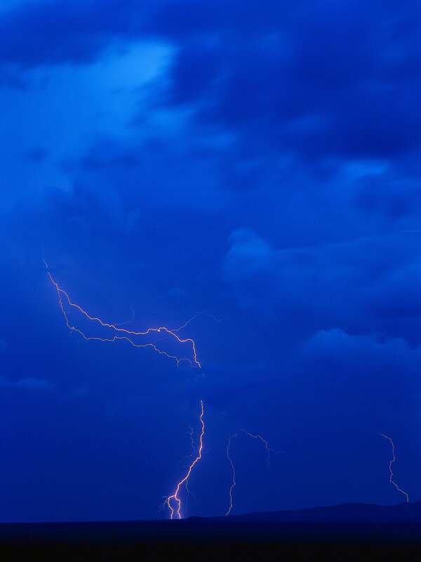 Lightning storm over dark landscape