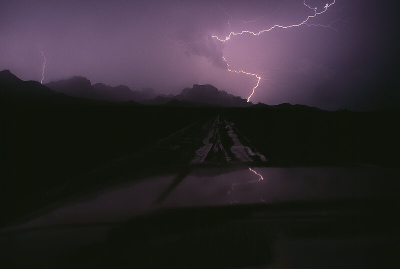 Lightning storm over desert road