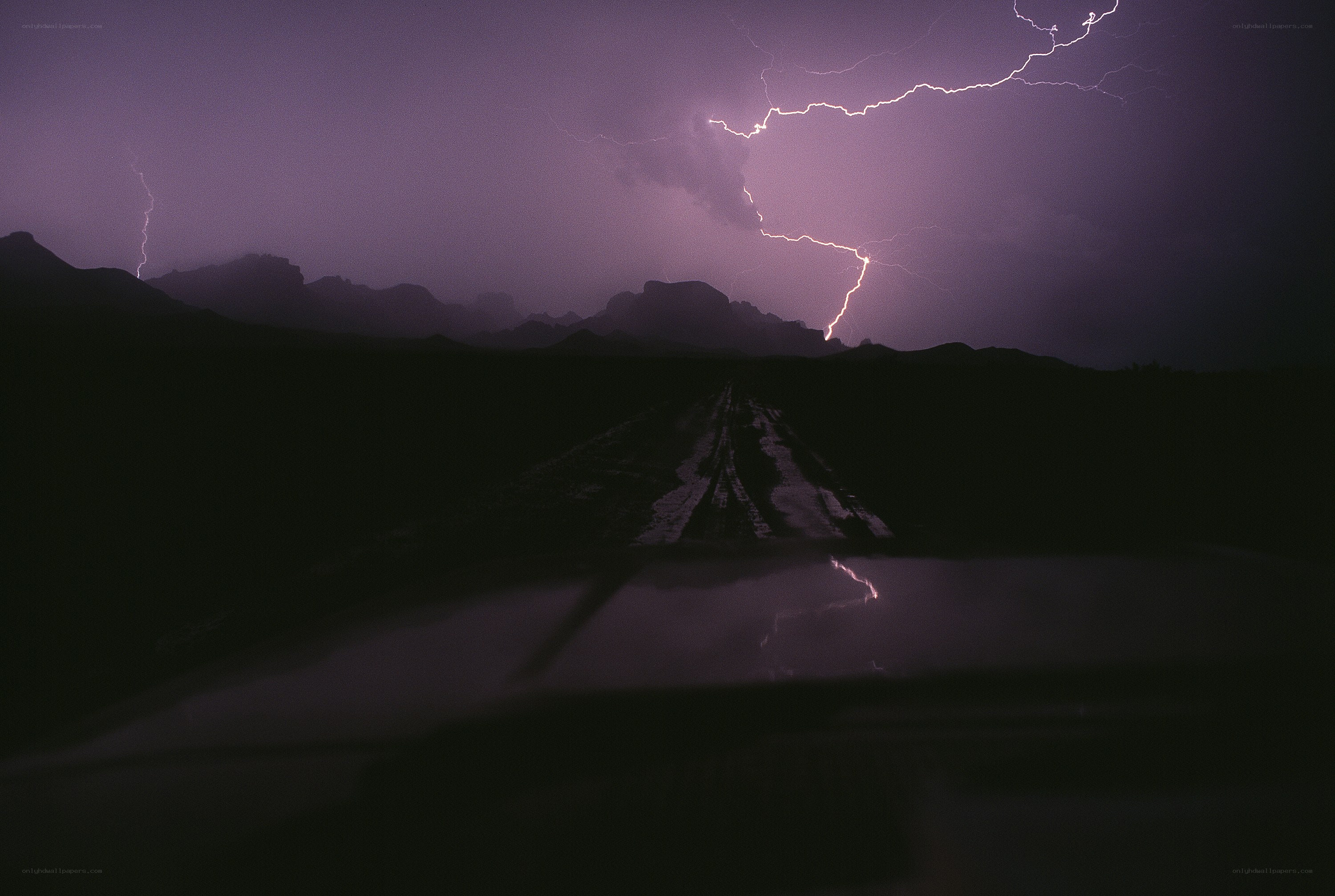 Lightning storm over desert road