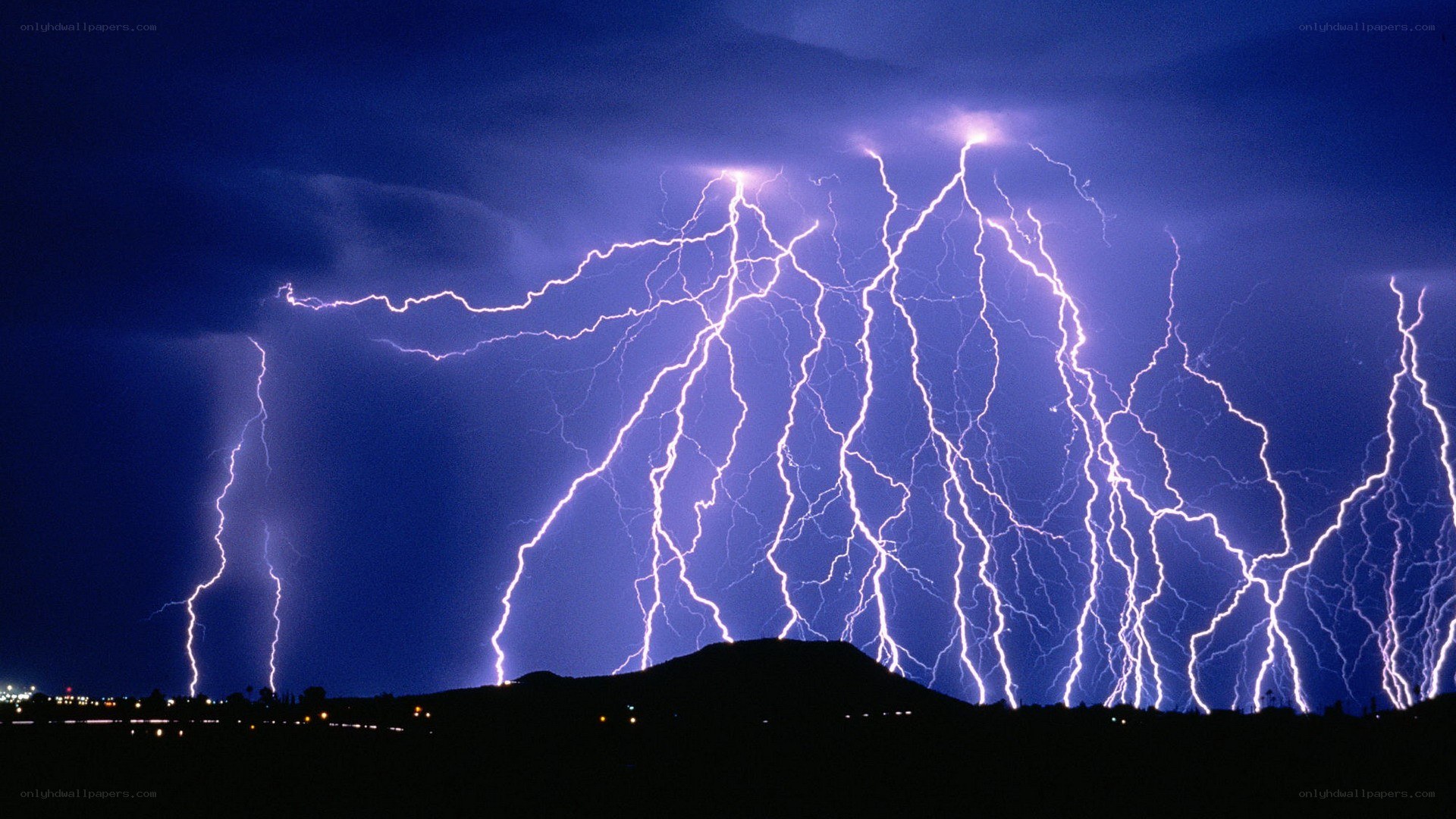 Lightning storm over hills