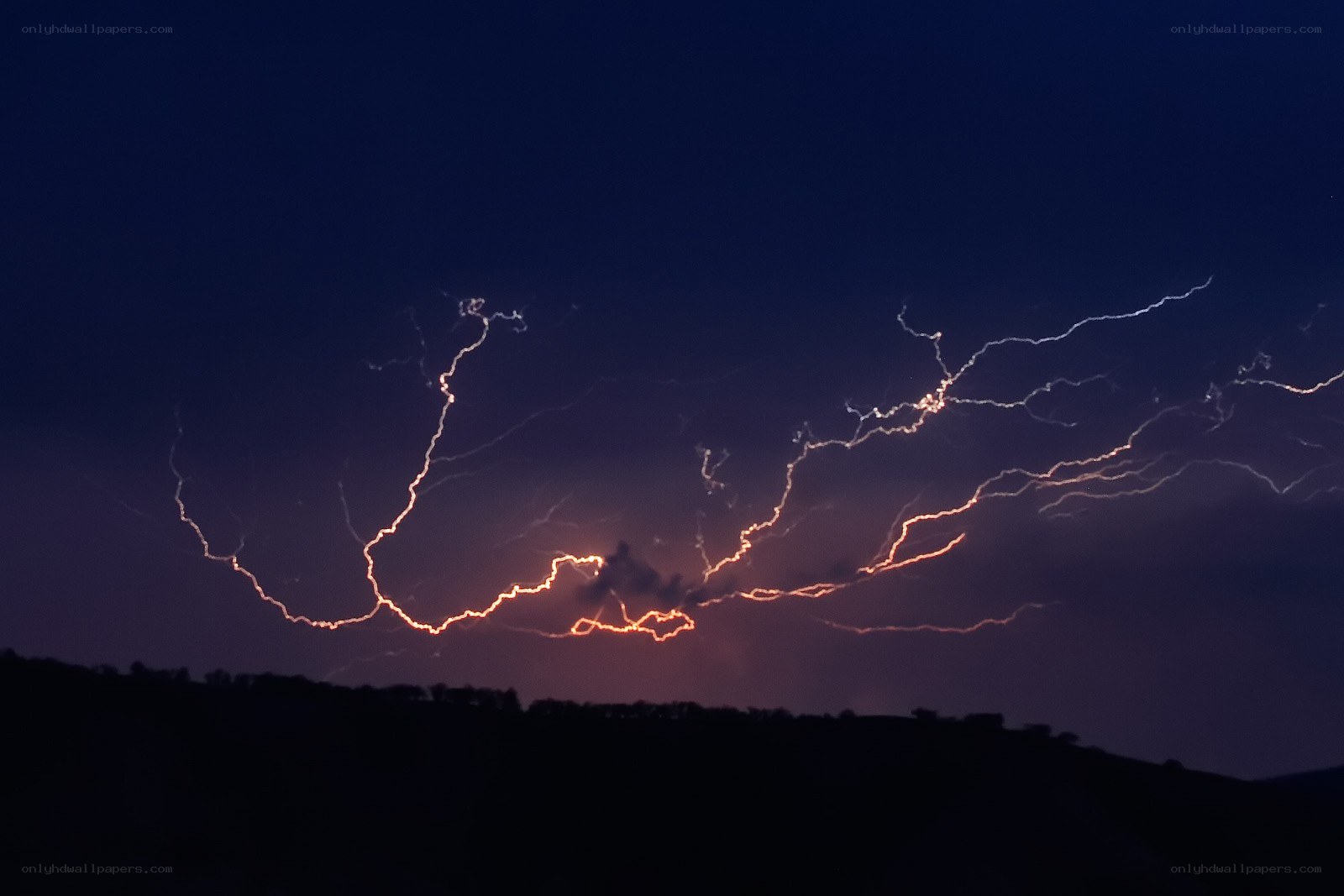 Lightning storm over hills