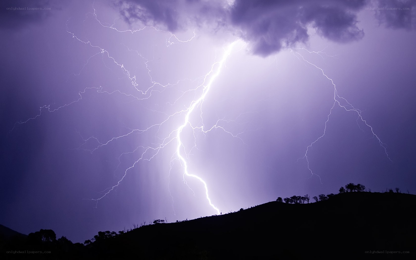 Lightning storm over hills
