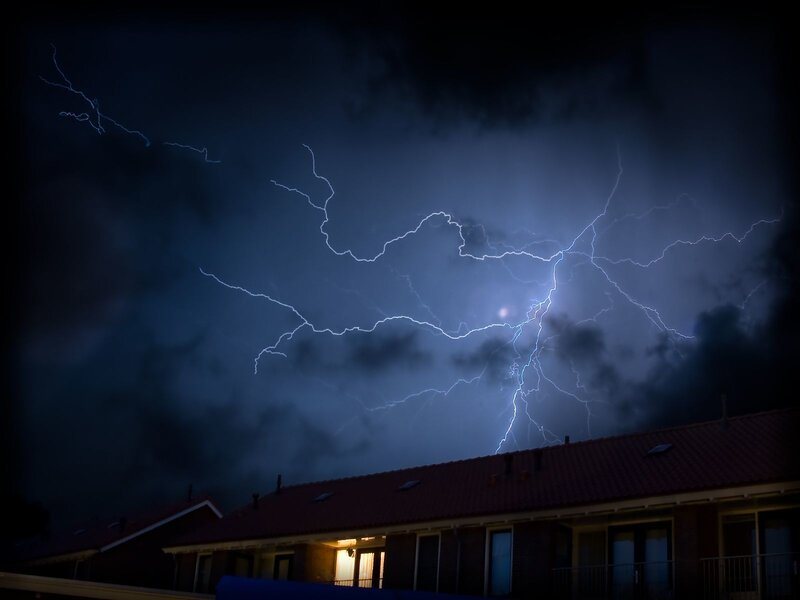 Lightning storm over houses