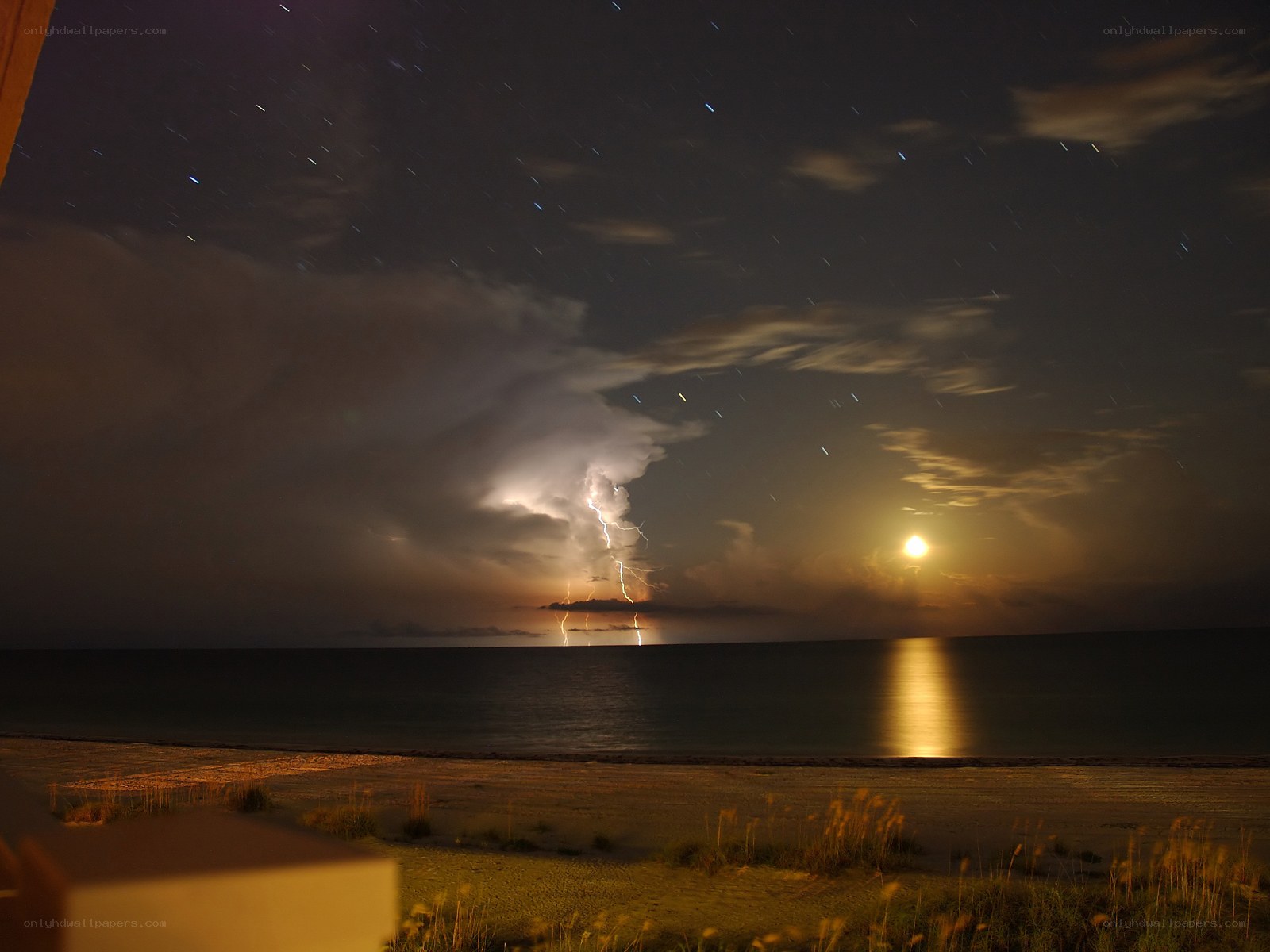Lightning storm over ocean at night