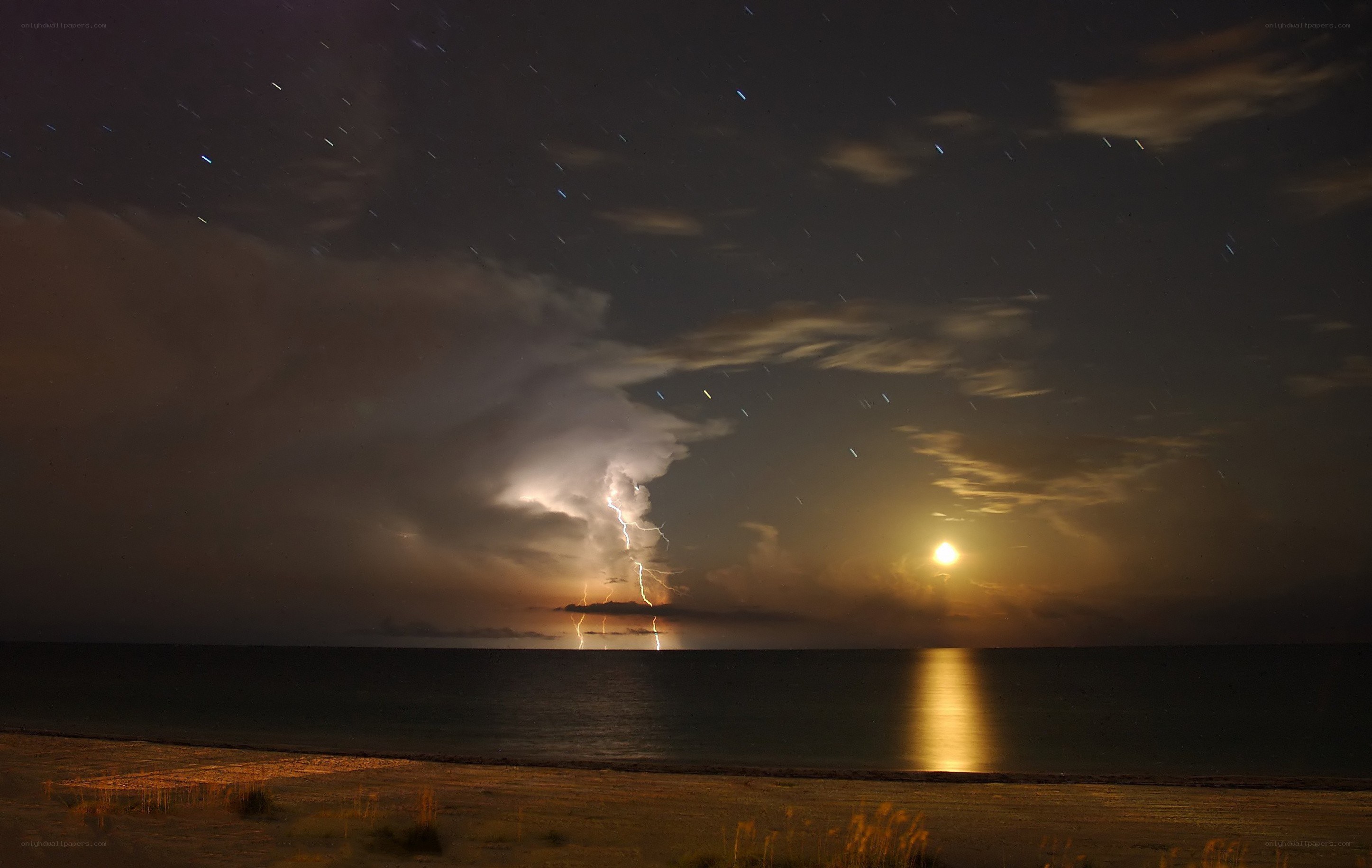 Lightning storm over ocean at night