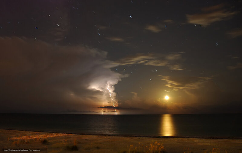 Lightning storm over ocean at night