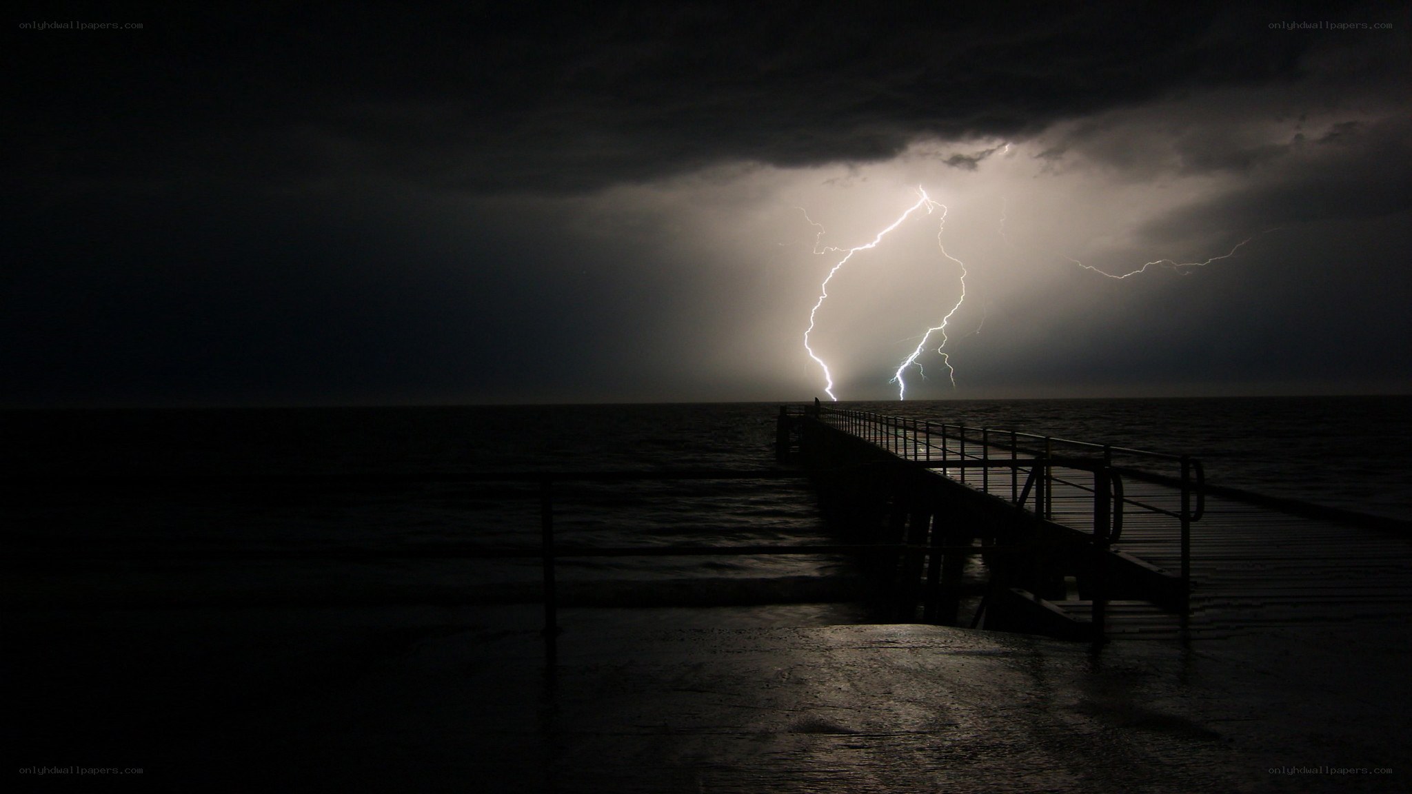 Lightning storm over ocean pier