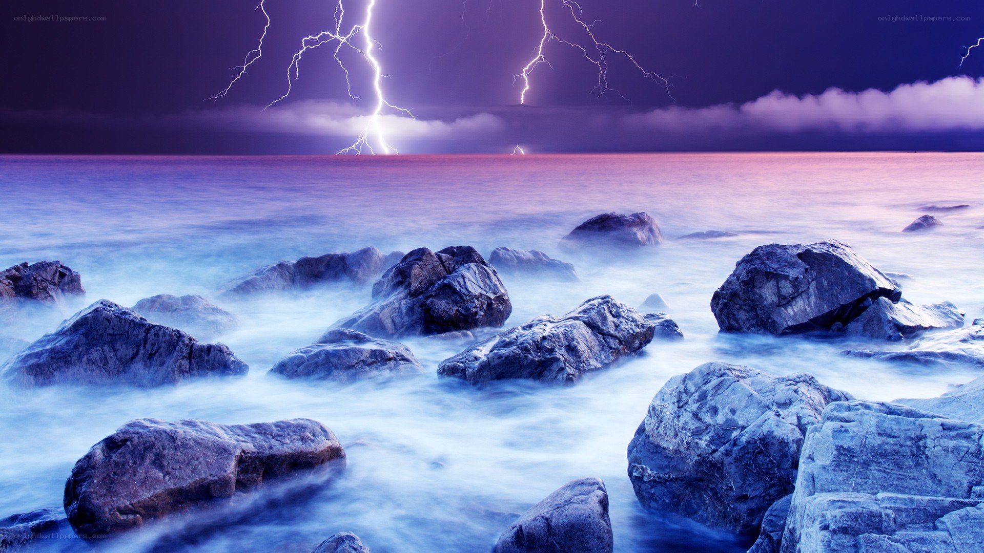 Lightning storm over rocky shore