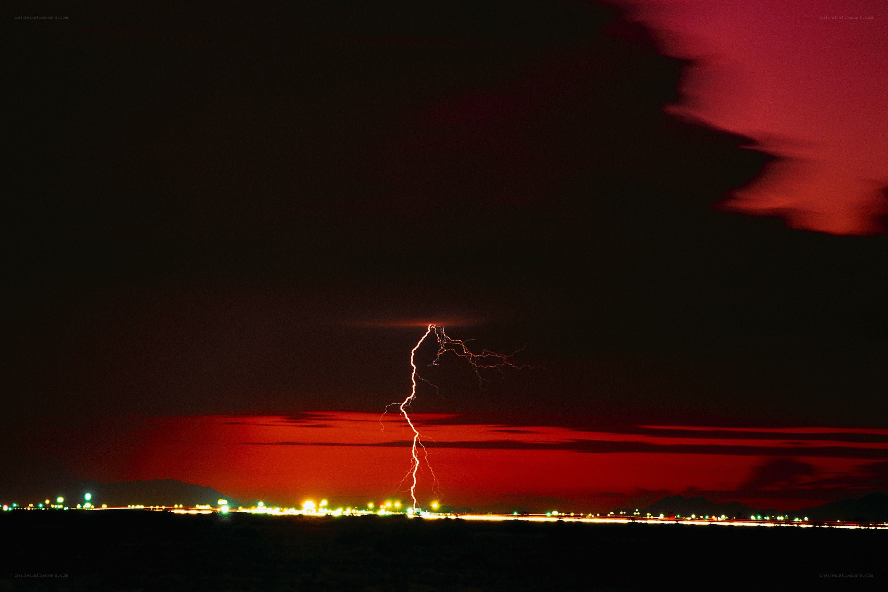 Lightning strike over city at night