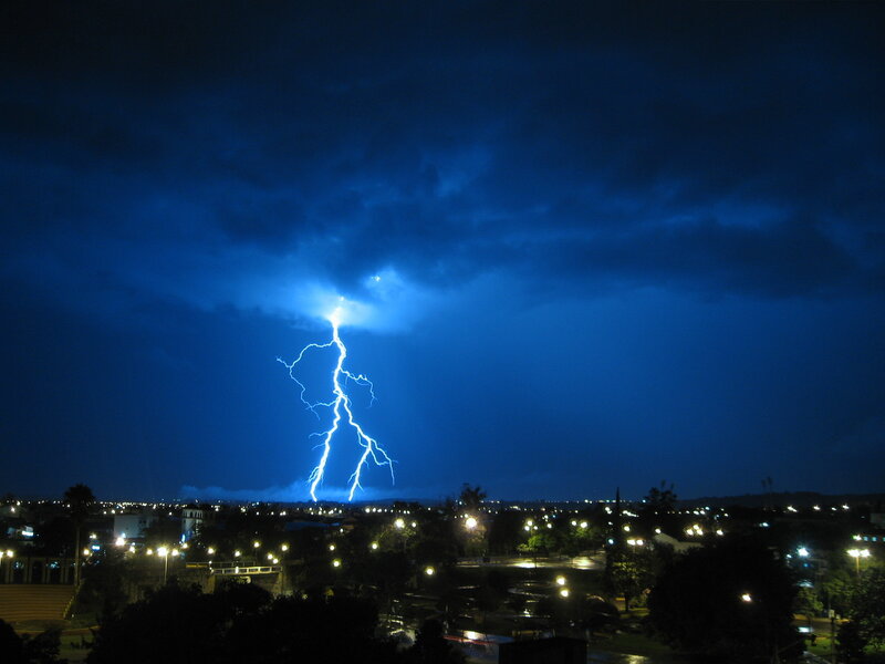 Lightning strike over city at night