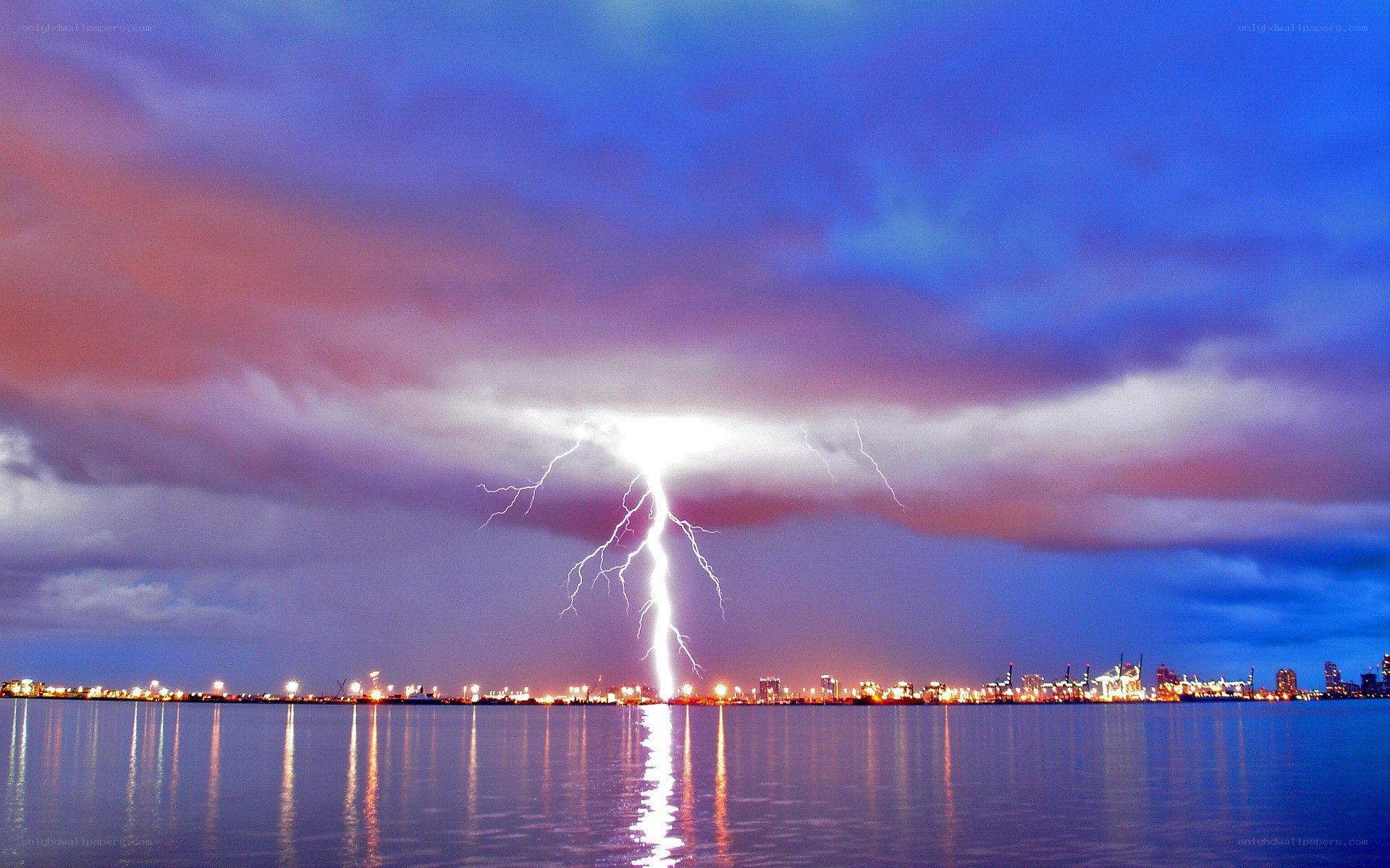 Lightning strike over city harbor